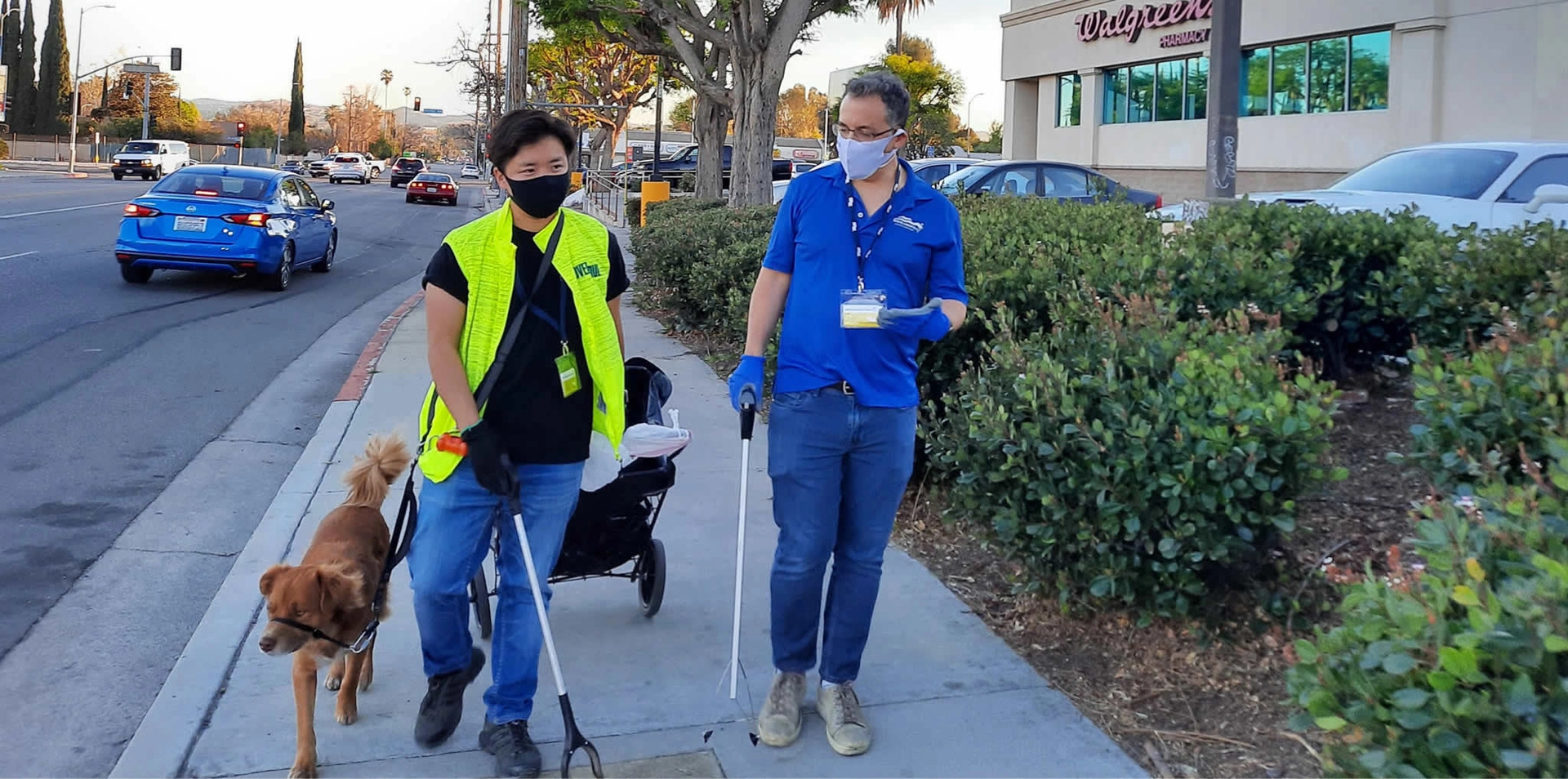 Blumenfield walking with volunteer and dog while cleaning park