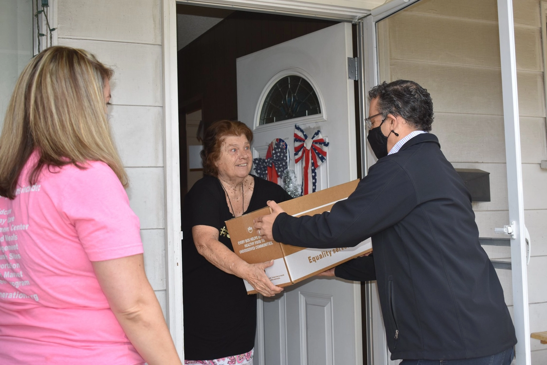Councilmember delivering food to a resident
